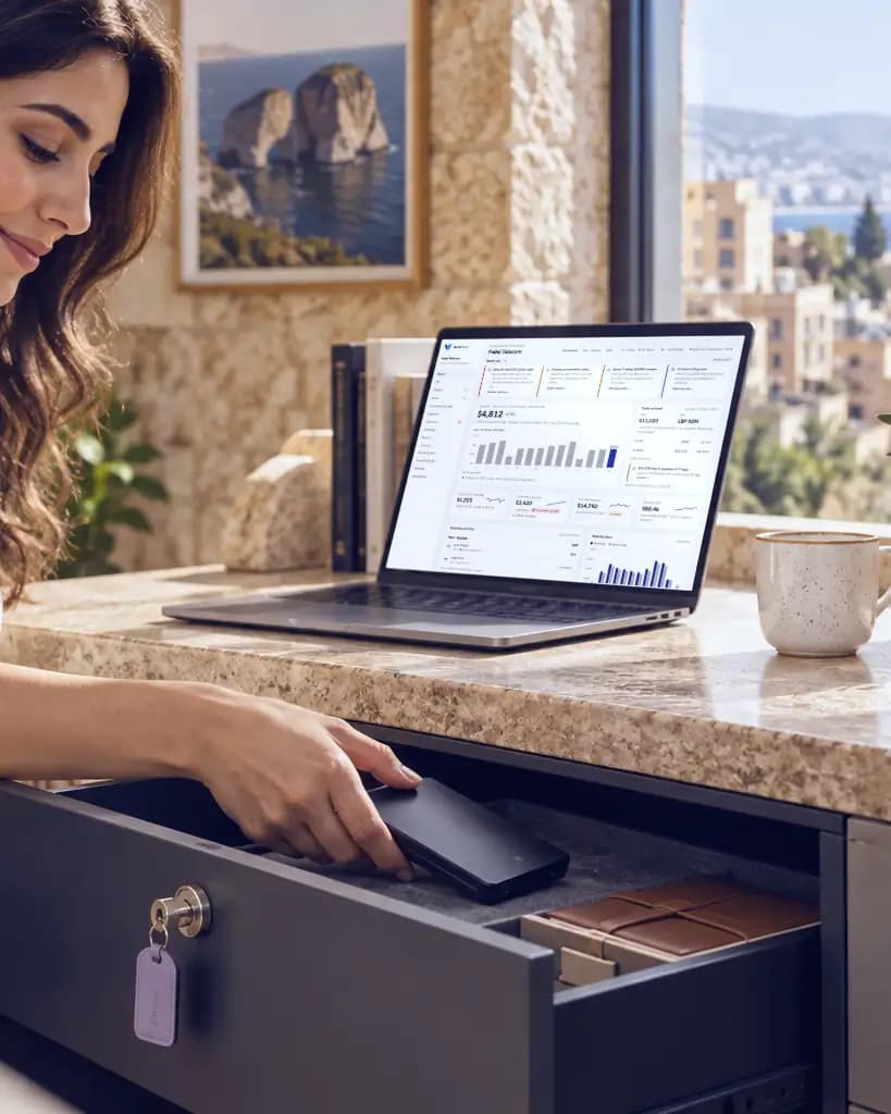 The owner at her desk, the laptop open on the day’s numbers, locking the cash drawer.
