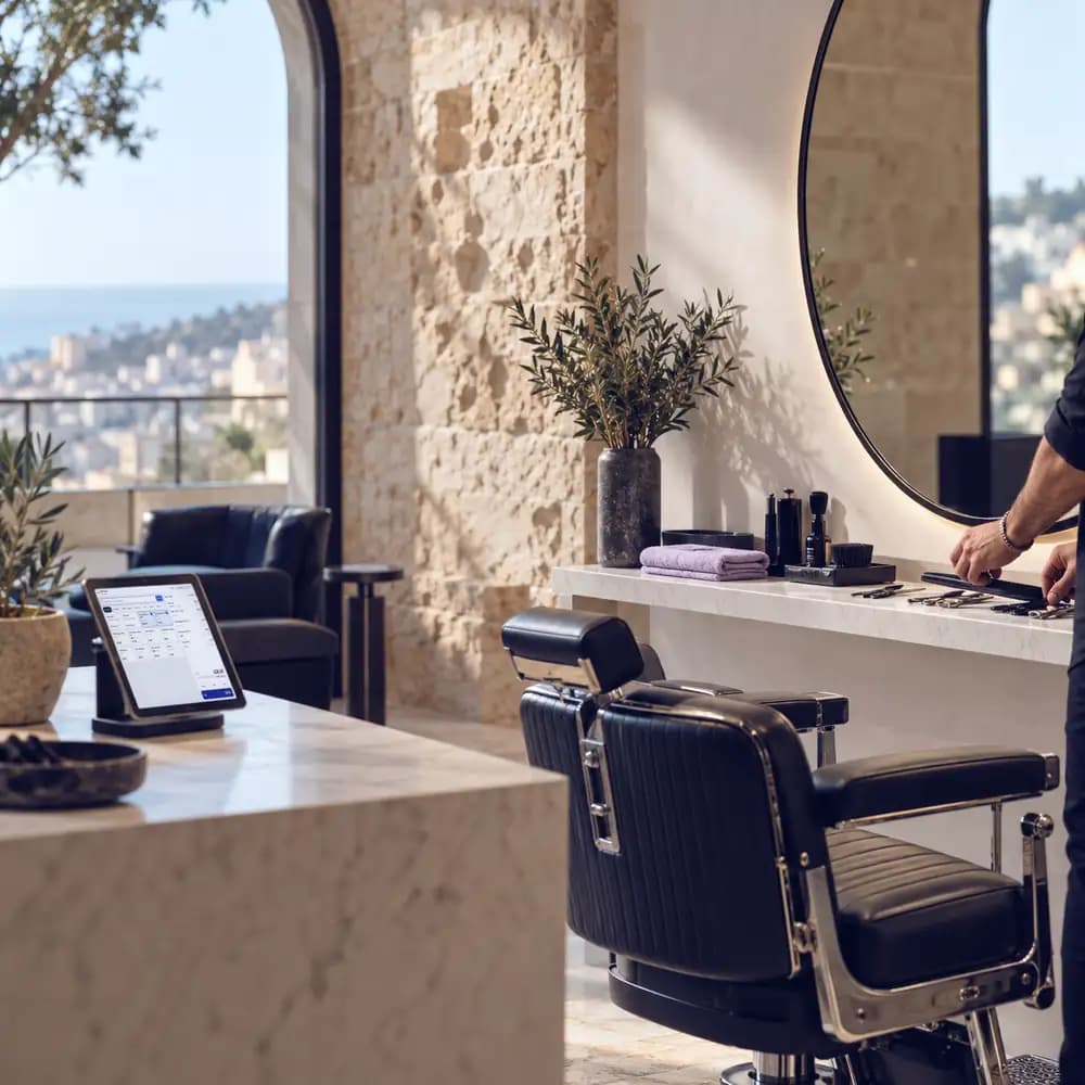 A barber's chair and a tablet terminal in a salon overlooking the city.